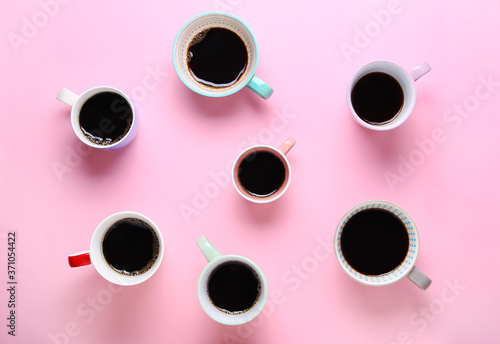 Group of different cups of coffee on pink background. Top view,flat lay,copy space.