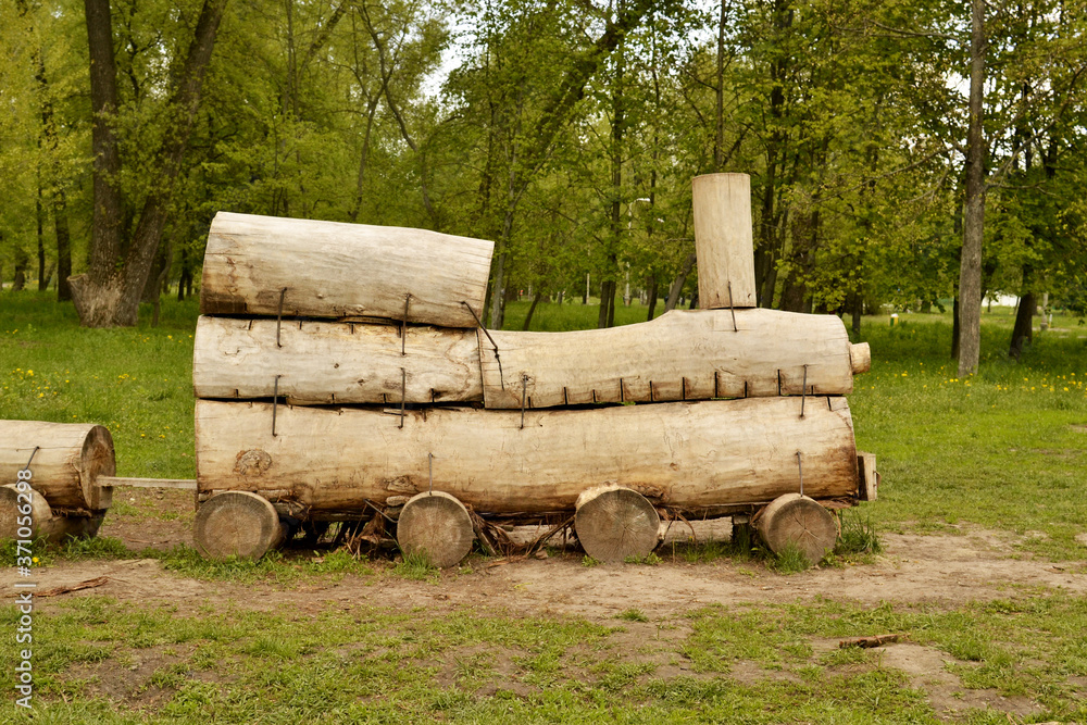 Wooden locomotive made of logs, the work of a carpenter Wooden locomotive made of logs, the work of a carpenter
