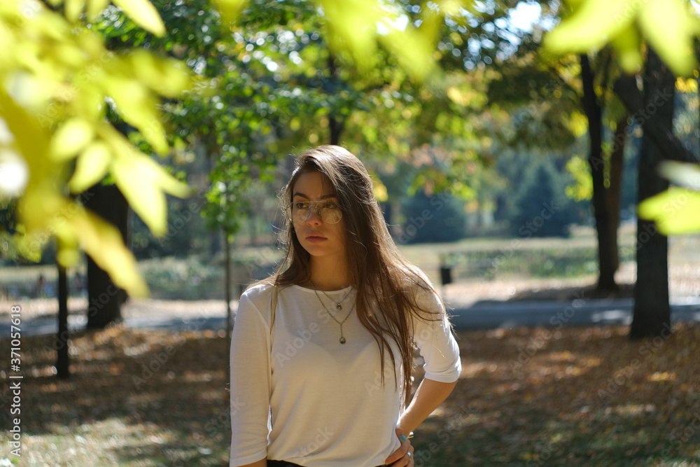 young woman in the park on a sunny autumn day young woman in the park on a sunny autumn day