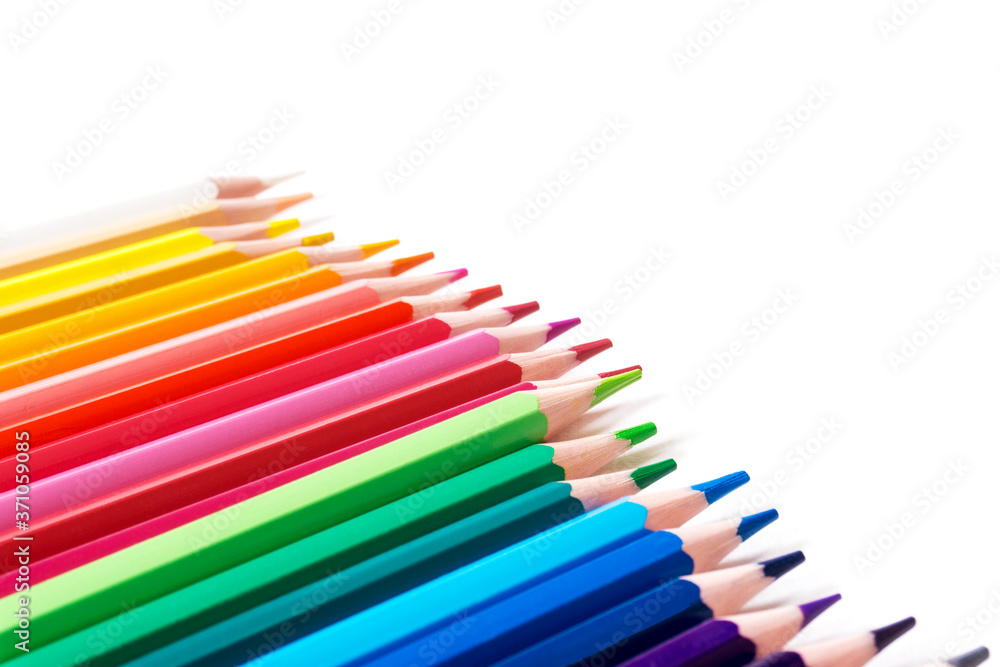 Colored pencils lying diagonally in a row, selective focus.