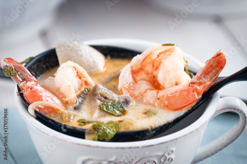 Spicy Thai soup Tom kha with coconut, bok choy and prawns
