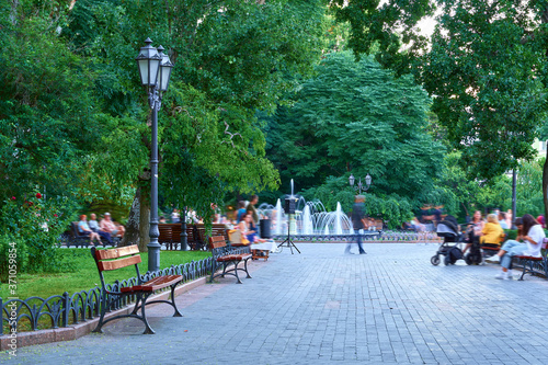 city Park - people walk and relax, green trees and a fountain at Deribasovskaya street, Odessa, Ukraine