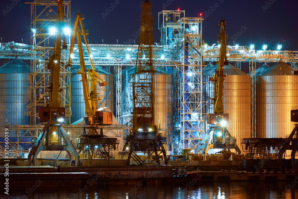 view of the industrial port at night - ships waiting for loading and unloading, cargo transportation by sea view of the industrial port at night - ships waiting for loading and unloading, cargo transportation by sea