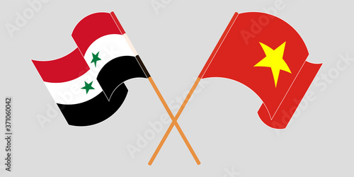 Crossed and waving flags of Syria and Vietnam