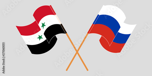 Crossed and waving flags of Syria and Russia