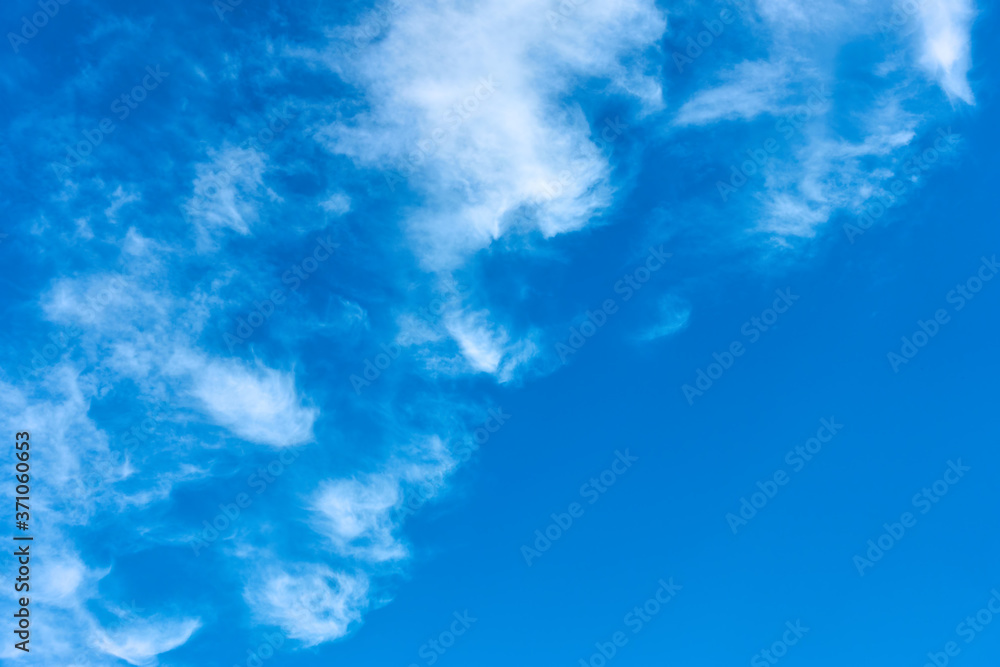 Blue sky with white curly clouds Blue sky with white curly clouds
