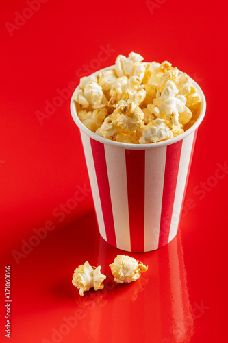 Sweet popcorn in striped paper cup.