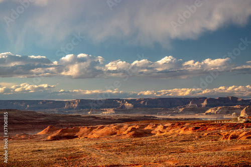 Rolling clouds and the evening sun shine gold on Page, AZ, USA