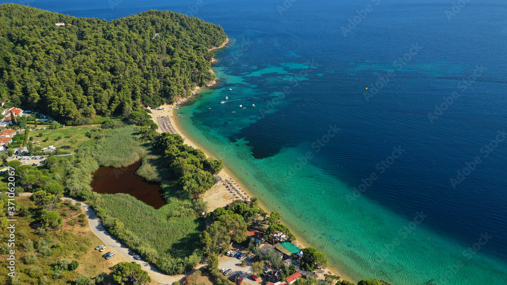 Aerial drone photo of popular paradise turquoise beach of Vromolimnos with small swamp next to it, Skiathos island, Sporades, Greece