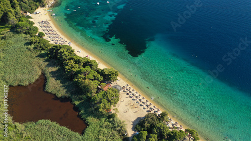 Aerial drone photo of popular paradise turquoise beach of Vromolimnos with small swamp next to it, Skiathos island, Sporades, Greece