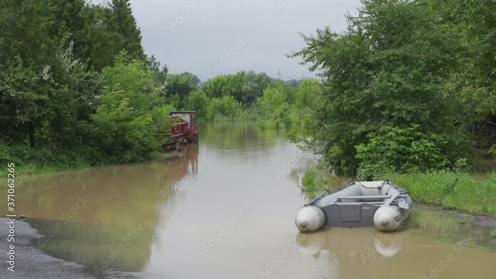Inflatable boat on the water during a flood. Natural disaster, flooded streets, dirty water Inflatable boat on the water during a flood. Natural disaster, flooded streets, dirty water