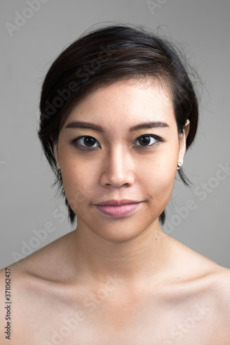 Portrait of young beautiful Asian woman with short hair shirtless