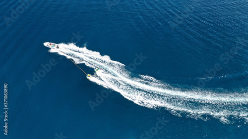 Aerial drone photo of extreme powerboat donut water-sports cruising in high speed in deep blue open ocean bay