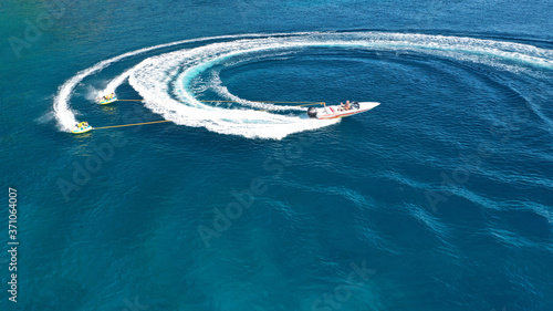 Aerial drone photo of extreme powerboat donut water-sports cruising in high speed in deep blue open ocean bay