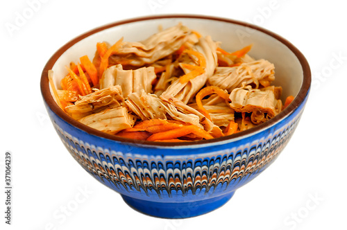 Spicy Chinese or Korean Yuba (tofu bamboo) and carrots salad on white background. Food product made from soybeans. Selective focus.