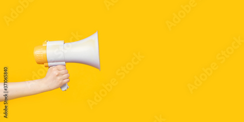 Woman's hand holding a megaphone, copy space.