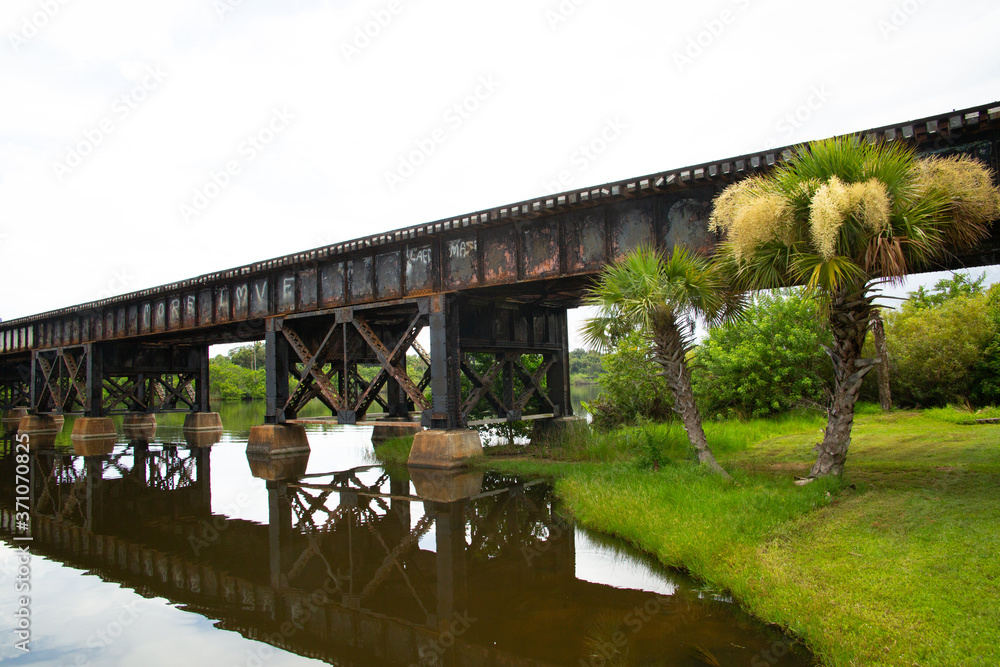 Fototapeta premium bridge over river, rusted train trestle over river.