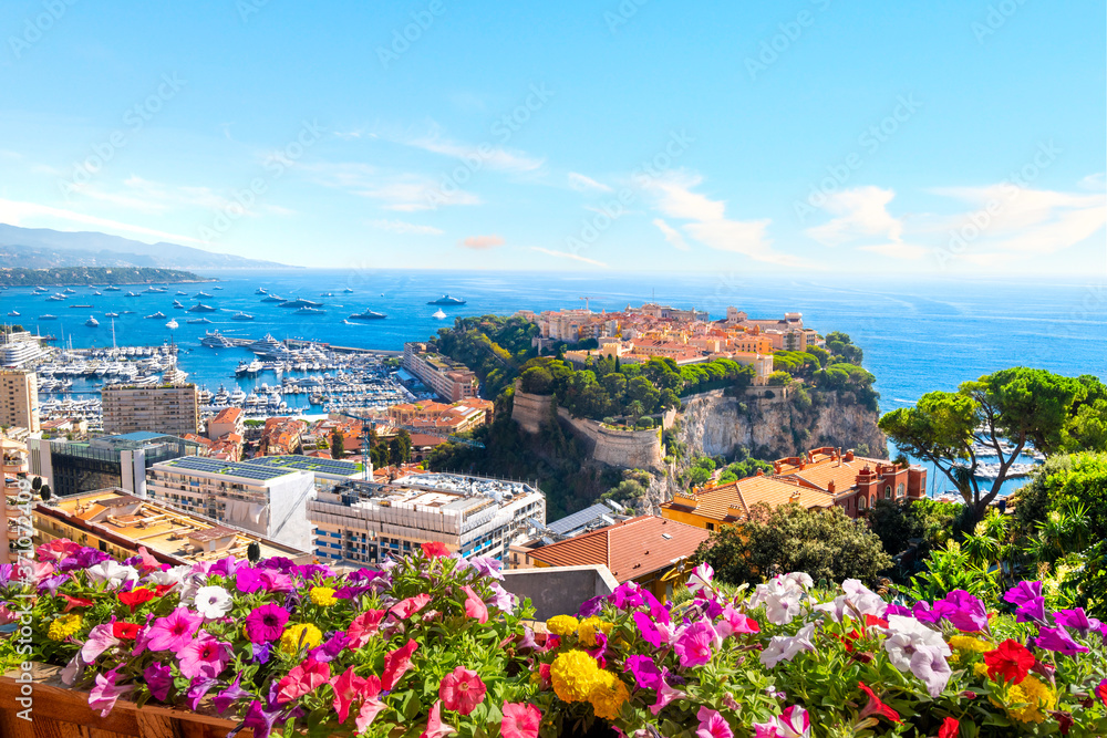 Obraz premium View of the city of Monte Carlo including the Rock, marina, Mediterranean Sea and cityscape along the coast of Monaco, on the French Riviera