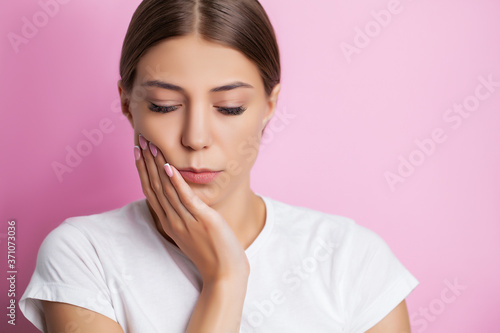 Tooth problems, an attractive woman is experiencing a painful toothache.