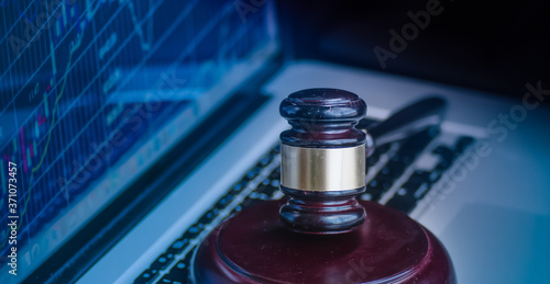 фотографія Judges gavel on keyboard with glowing computer screen monitor background