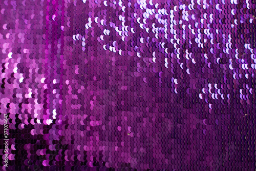 Glamor lilac Background with Sequins close-up. Abstract Texture scales with shiny sequins on fabric.