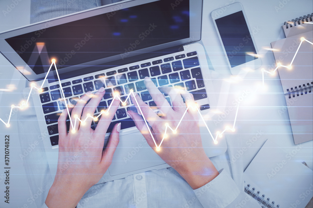 Double exposure of woman hands working on computer and forex chart hologram drawing. Top View. Financial analysis concept. Double exposure of woman hands working on computer and forex chart hologram drawing. Top View. Financial analysis concept.