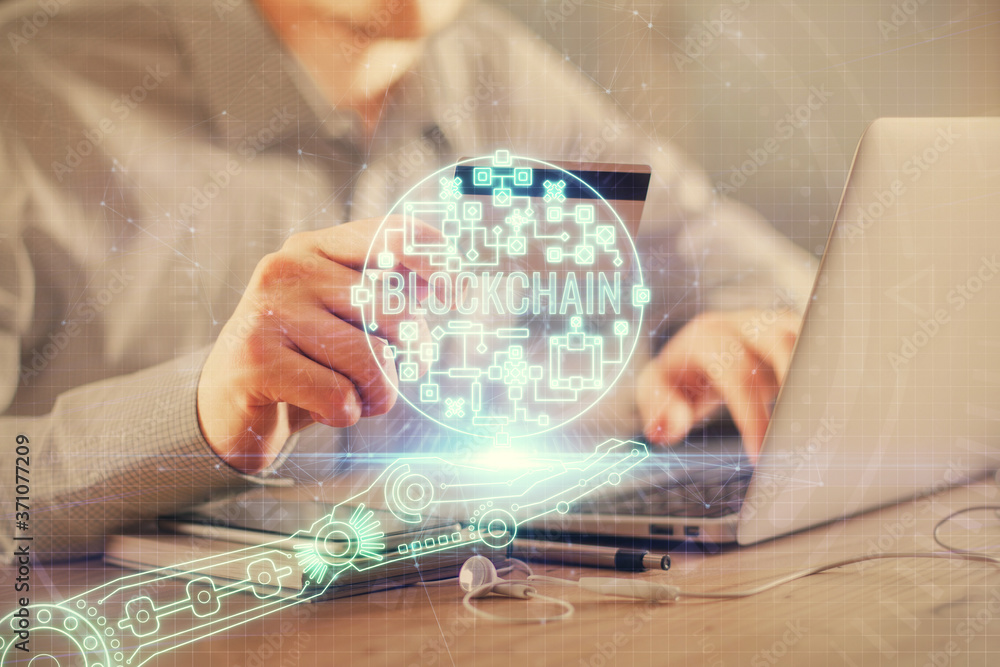Double exposure of man hands holding a credit card and crypto business theme drawing. Digital blockchain and E-commerce concept. Double exposure of man hands holding a credit card and crypto business theme drawing. Digital blockchain and E-commerce concept.