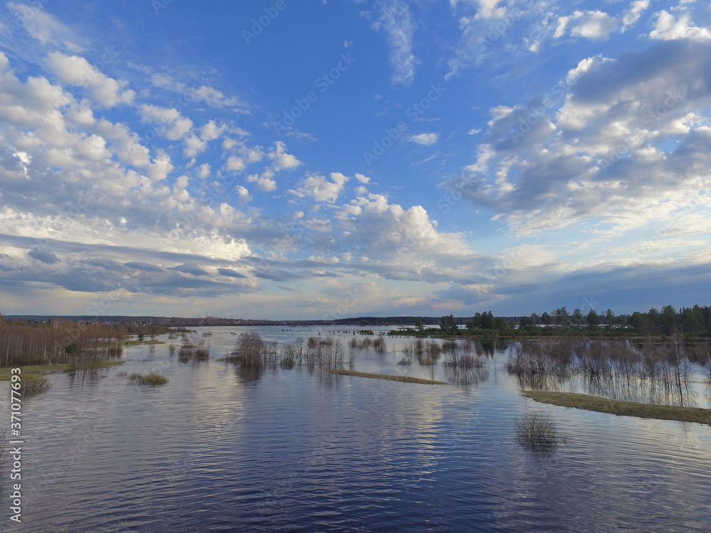 Сlouds over flooded fields in the Vychegda river valley, Komi Republic, Russia.