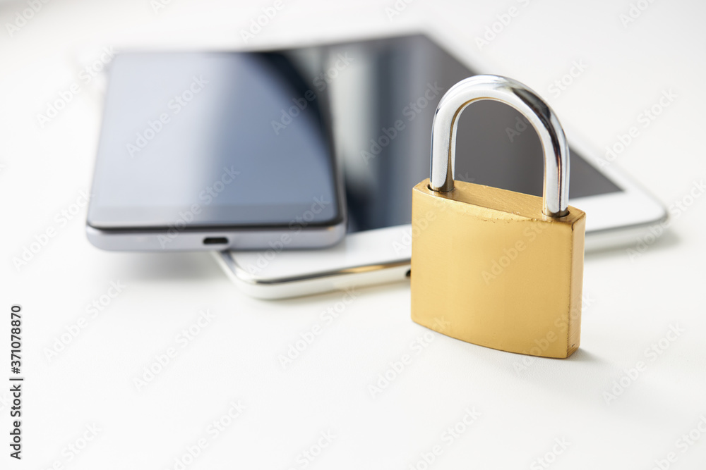 tablet pc and smartphone with padlock over white background. digital data security concept. virus protection software concept tablet pc and smartphone with padlock over white background. digital data security concept. virus protection software concept