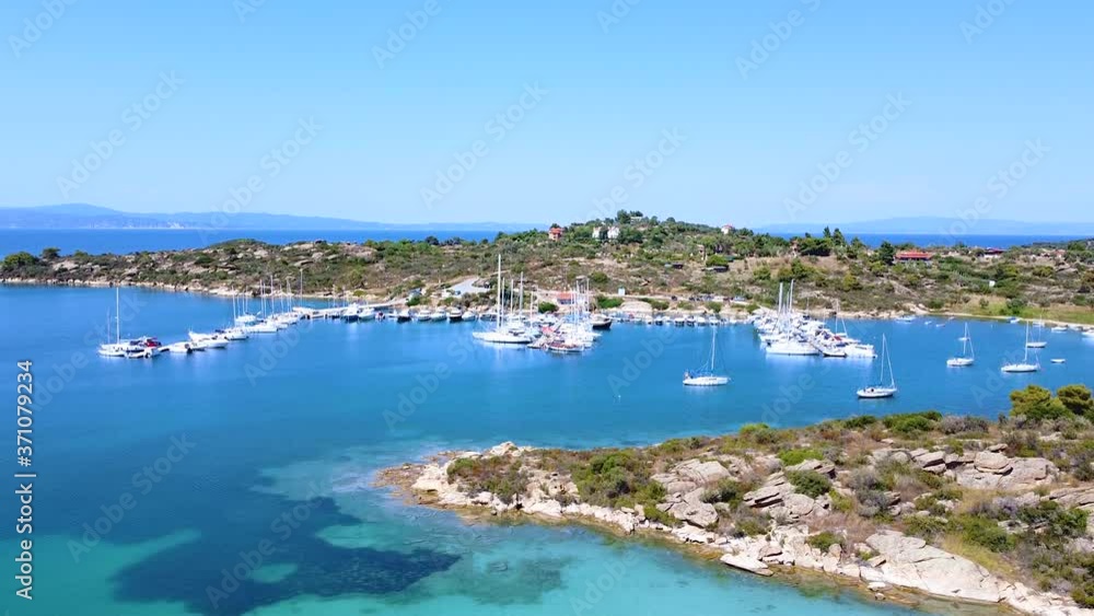 Motorboats and sailboats anchored in harbor with amazing blue sea on sunny summer day. Aerial view Motorboats and sailboats anchored in harbor with amazing blue sea on sunny summer day. Aerial view