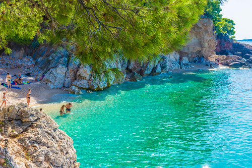 Fototapeta Naklejka Na Ścianę i Meble -  HVAR, CROATIA, AUGUST 8 2019: Tourists swimming in the beautiful and crystal water of Jagodna Beach in Hvar Island, Adriatic Sea