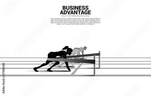 Business concept of competition and business advantage. Silhouette of businesswoman ready to run from start line with catapult sling shot on racing track.
