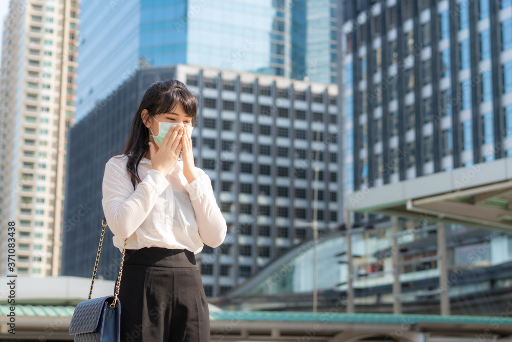 Young Asian businesswoman in white shirt going to work feeling sick with cough wears protection mask . Young Asian businesswoman in white shirt going to work feeling sick with cough wears protection mask .