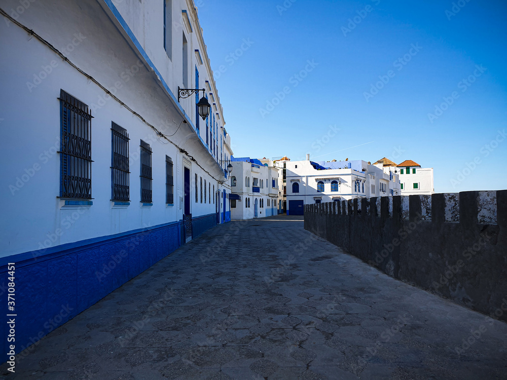 Empty street in the white city of Asilah, Morocco