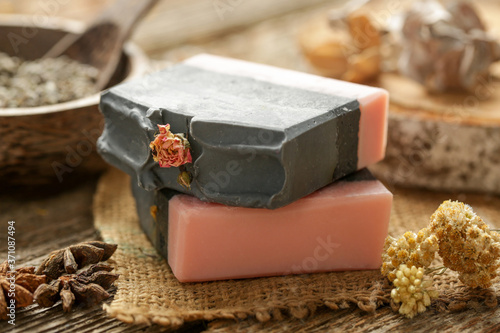 Handmade soap bar with herbal ingredients around. Homemade toxic-free natural organic soap. 