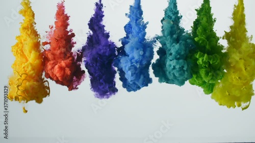 Palette of bright colored liquids exploding and mixing in slow motion.