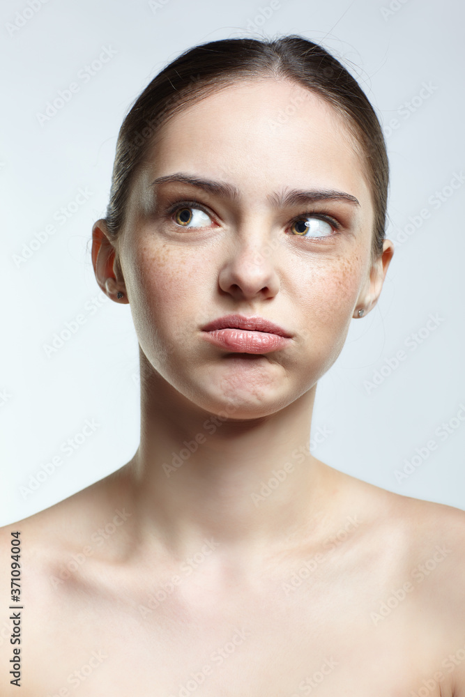 Headshot of emotional female face portrait with tired of everything and misunderstanding facial expression. Headshot of emotional female face portrait with tired of everything and misunderstanding facial expression.