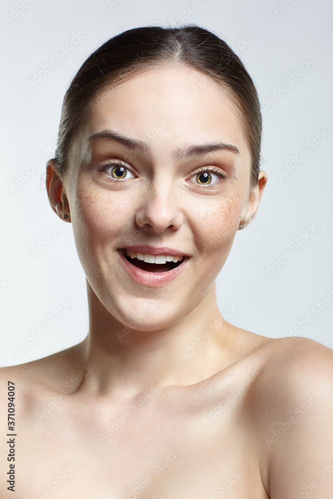 Headshot of emotional female face portrait with wonder facial expression.