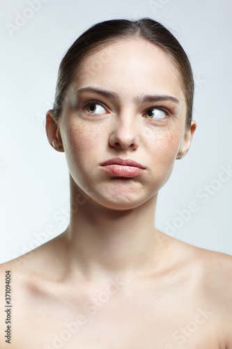 Headshot of emotional female face portrait with tired of everything and misunderstanding facial expression.