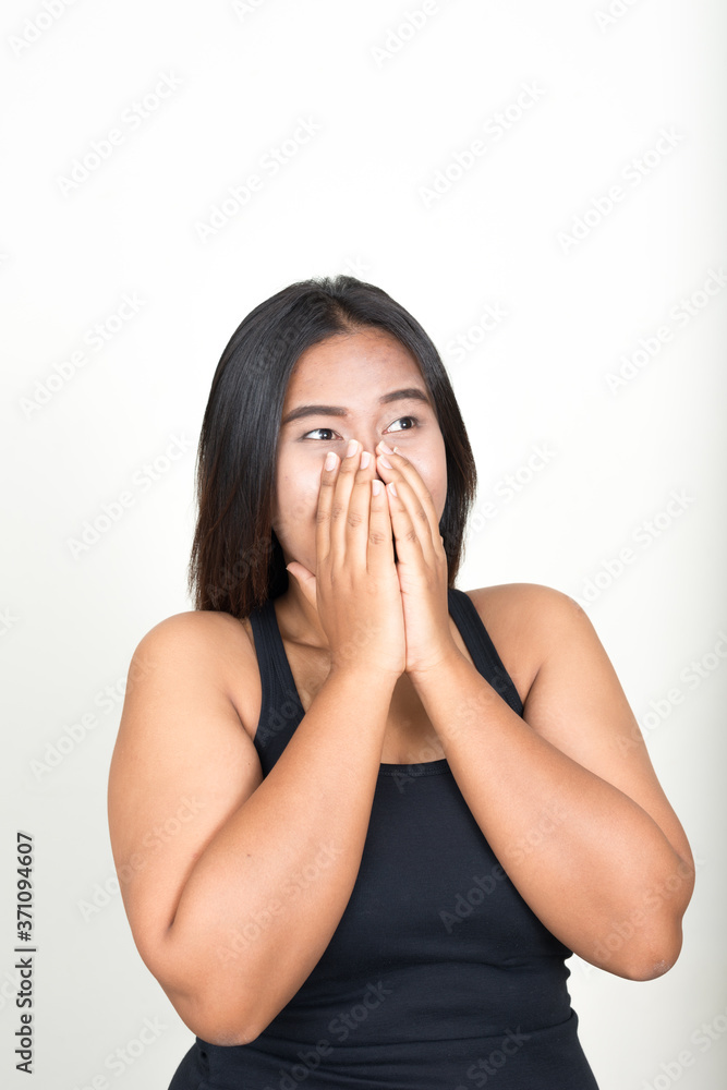 Portrait of young overweight Asian woman against white background Portrait of young overweight Asian woman against white background