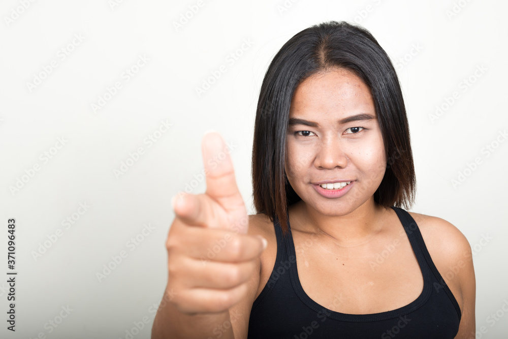 Portrait of happy young overweight Asian woman Portrait of happy young overweight Asian woman