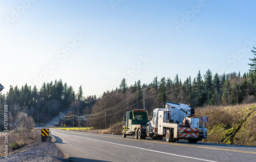 Wallpaper Mural Big rig towing semi truck tow another broken big rig semi truck with application running on the road with hill and trees Torontodigital.ca