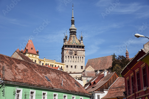 Obraz na płótnie Sighisoara Clock Tower overhanging colored house in the historic town center w salonie