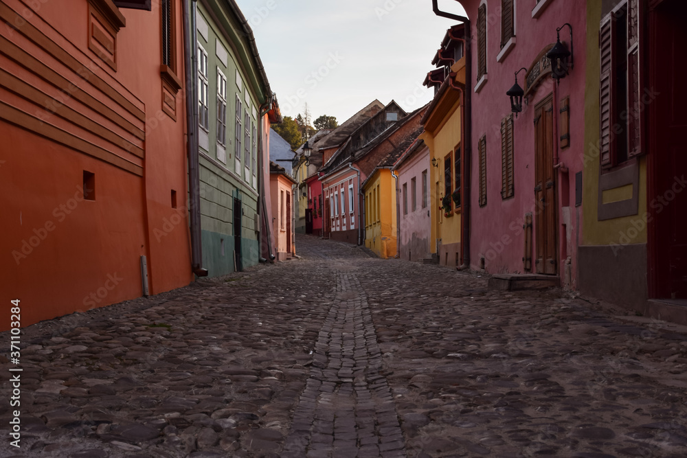 dusk in historic colorful streets of Sighisoara with stone floor