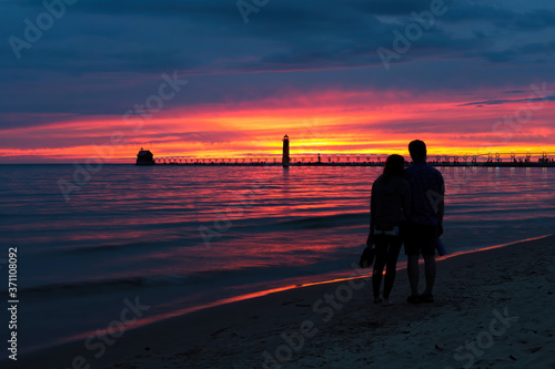 Grand Haven lighthouse sunset on the beach, Lake Michigan