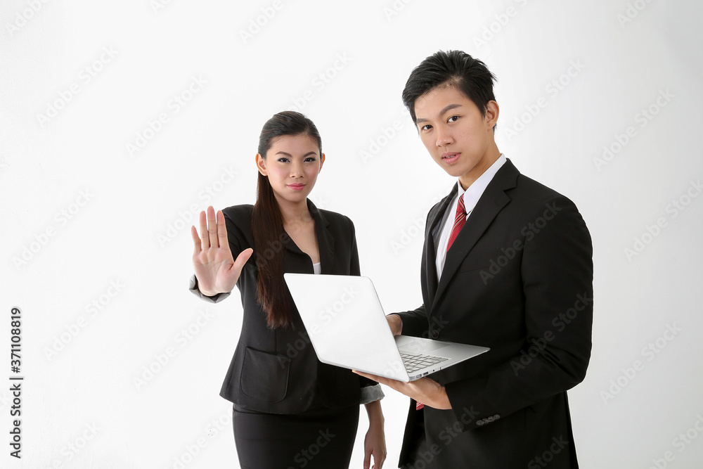 Asian young Chinese man woman wearing formal business office ware on white background holding laptop stop hand sign Asian young Chinese man woman wearing formal business office ware on white background holding laptop stop hand sign
