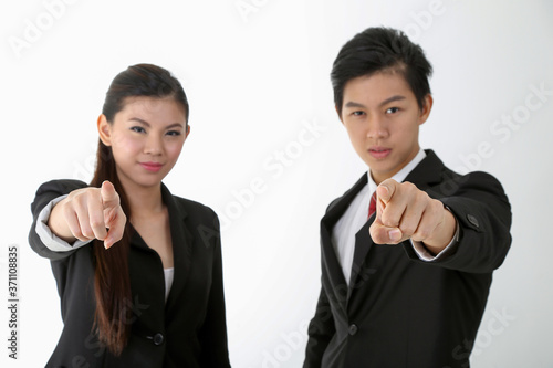 Asian young Chinese man woman wearing formal business office ware on white background point at camera