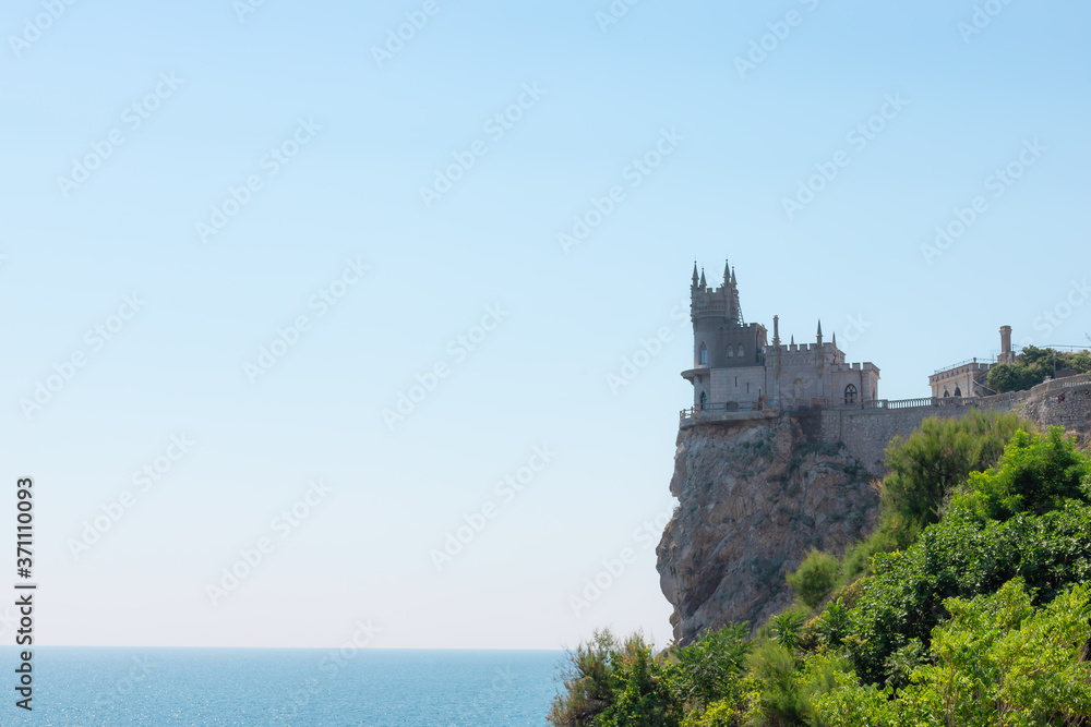 Beautiful castle Swallow's Nest on a rock near the blue sea on a summer day. Famous landmark of Crimea.