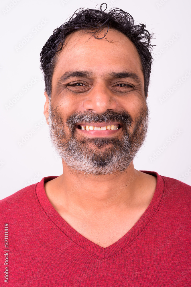 Fototapeta premium Portrait of happy mature handsome bearded Indian man
