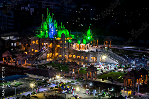 Night time green lighting on Shree Swaminarayan temple at night, Pune, India. photo